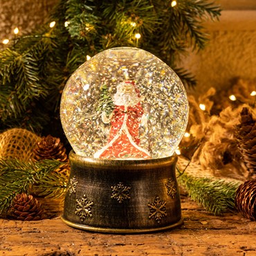 Boule de Neige en verre avec le Père Noël, base marron à piles, h. 17 cm, led blanc chaud