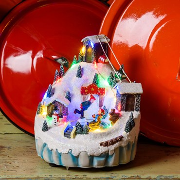 Battery operated Polyresin Christmas Village, Mountain Landscape with Cable Car and Ice Skaters, h 16.5 cm