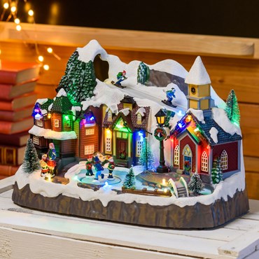 Polyresin Christmas Village, Skiers on Track and Rotating Ice Skaters, h 24 cm, with Christmas Music